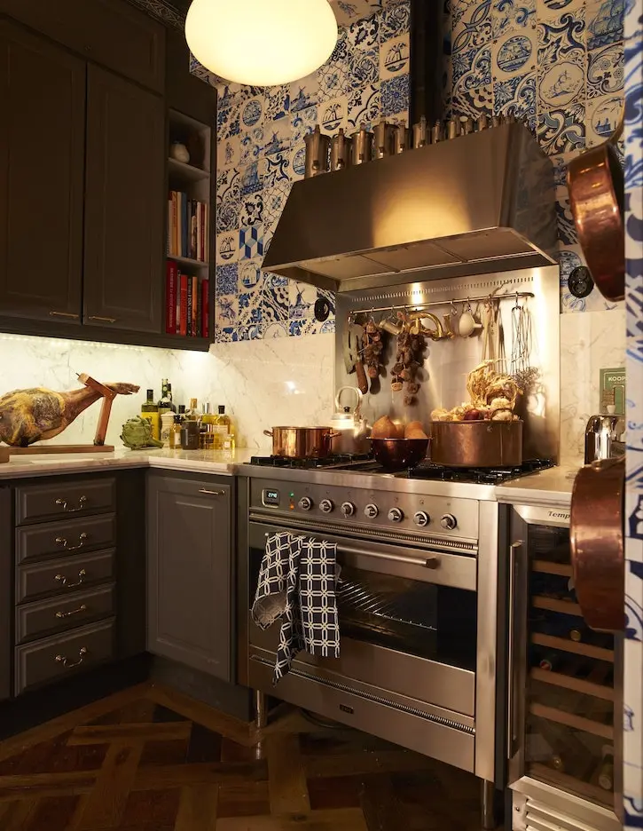 Kitchen with blue-and-white Delft-pattern wallpaper, copper pans and a stainless range, kitchen in the Old Town, Stockholm